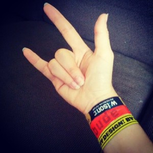 My hand with a By Design Conference bracelet